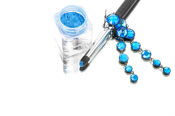 Blue stone earrings and blue eyeshadows on white