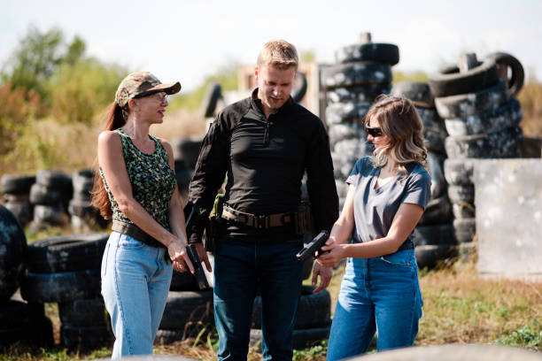 istock Girls learn to shoot a pistol at a shooting range with an instructor 1803901130