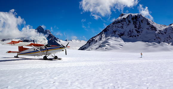 Tourist Ski Plane landing on a snow field in the Southern Alps on the south island of New Zealand.
