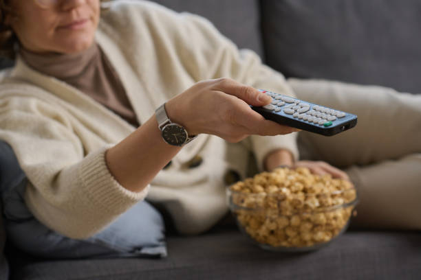 istock Woman watching TV with popcorn 1803928162