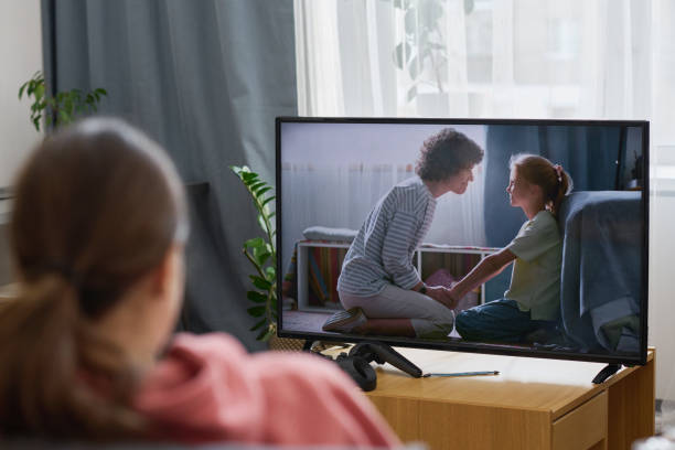 istock Girl watching TV at home 1803931189