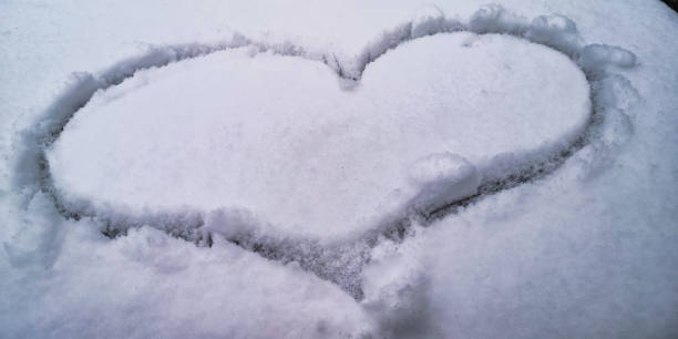 istock Silhouette of a heart drawn on the snow 1803946533