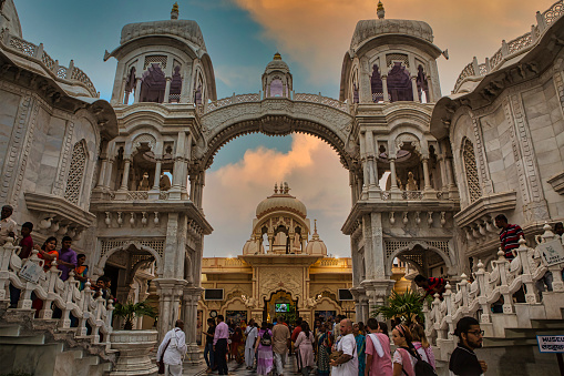 Vrindavan, Uttar Pradesh, October 19th 2019: In the evening time, people roaming and enjoying in front of main entrance gate of Sri Krishna-Balaram Mandir. It is a Gaudiya Vaishnava temple in the holy city of Vrindavan. It is one of the main ISKCON temples in India and internationally.