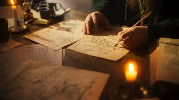 Close Up of Inscriptions and Notes With Hand of Old Renaissance Male Using Ink and Quill to Write New Ideas. Dedicated Historian Taking Notes, Inventing New Theories, Innovating