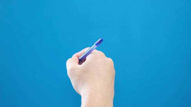 istock A ballpoint pen writes on a blue background 1803962457