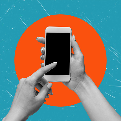 Cell phone with black screen in female hands, isolated on orange and blue background. Smartphone mockup. Modern art. Modern design