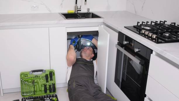 plumber fixing under the sink in the kitchen. pipe cleaning plumber. clean the drain and sink - sink drain plumber domestic kitchen imagens e fotografias de stock