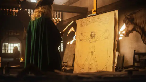 Photo of The Blend of Art and Science: Documentary Shot of Leonardo Da Vinci Working on his Famous Piece of the Vitruvian Man in his Workshop. Historical Moment Depiction of Talent and Brilliance