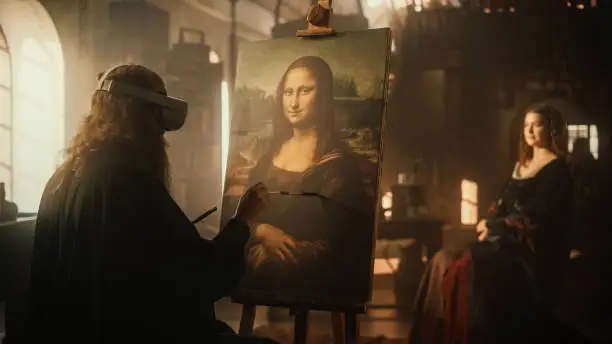 Photo of The Past Meets the Future: Back View of Leonardo Da Vinci Creating the Painting of the Mona Lisa on Canvas While Wearing VR Goggles in his Workshop. Futuristic Recreation of Historical Figure