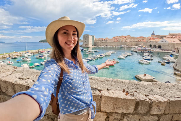 istock Young Woman Taking Selfies In Dubrovnik Bay 1803990938