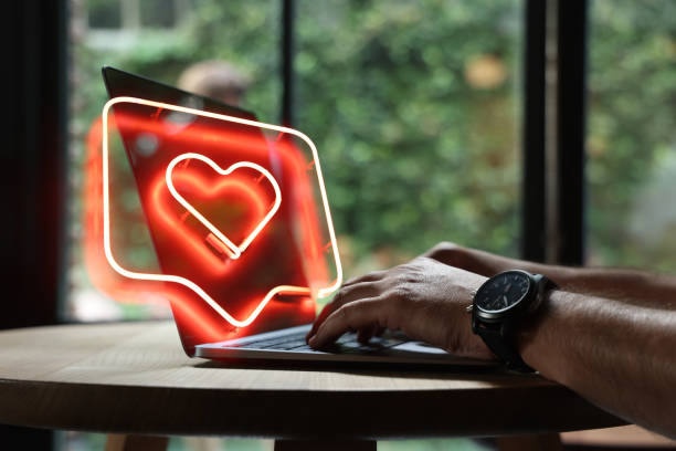 Man using laptop with heart shape - fotografia de stock