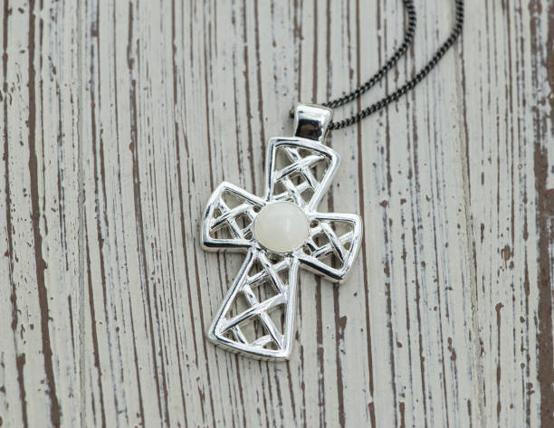 istock Vintage cross pendant on white wooden background 1803992643