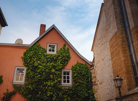 spring trip to Europe. Travel and German sightseeing locations. scenic view to facade of old historic houses somewhere in Erfurt city, details of ancient medieval houses, windows and doors