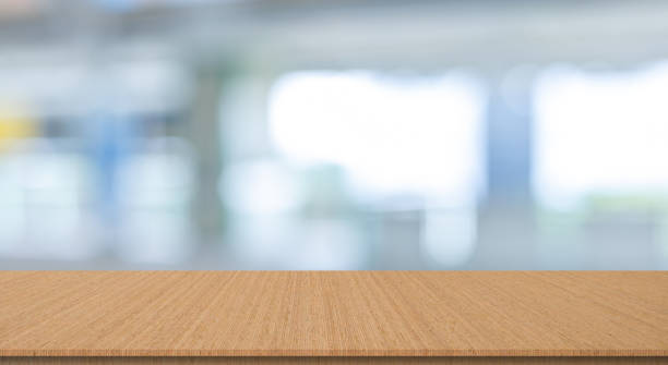 istock abstract blur inside office with opening window background and modern wood table perspective for show ads or promote product and content on display concept 1803998200