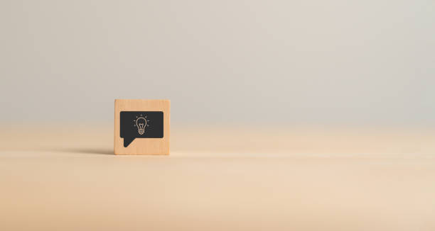 istock New idea, solution, suggestion, sharing concept.  Wooden cube blocks  with light bulb on minimal background and copy space. Business analysis, review, sharing, strategy suggestion for business growth. 1803998803
