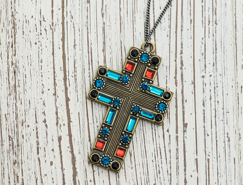 cross necklace on wood background