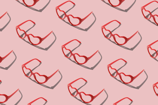istock Pattern made with red heart shaped sunglasses on pastel color background 1804005632