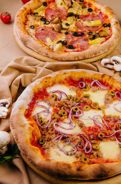 istock tuna pizza and artichoke pizza with ham 1804006226