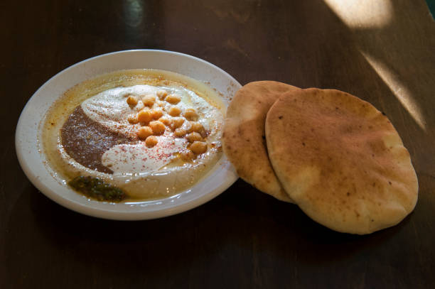 istock Fresh hummus and pita bread on a table 1804006570