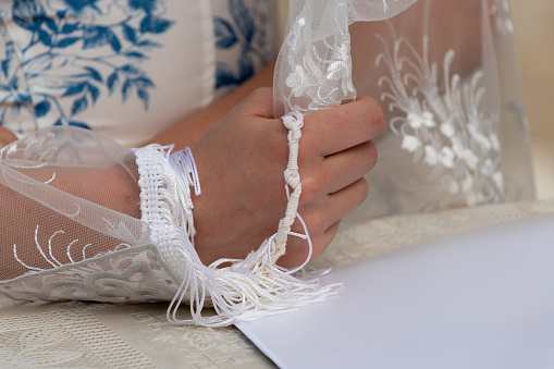 Dressmaker cutting lace fabric for wedding dress decoration