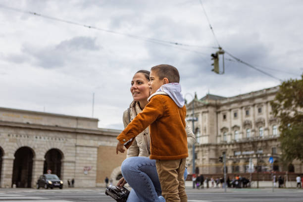 Mother and sun walking. They are tourists in Vienna Austria.  They are in Mariahilfer Street