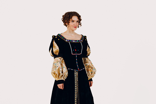 Portrait of a young aristocratic woman dressed in a medieval dress on white background.