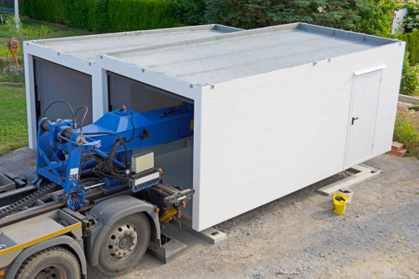 istock The second half of a prefabricated garage is placed on the strip foundation 1804007440