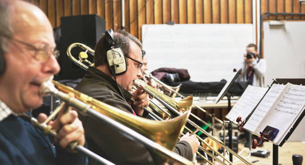 Hands of man playing the trombone in the orchestra