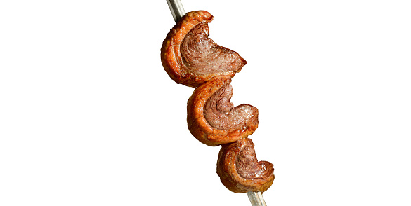 Close up picture of a typical Colombian picada (beef steak, chicharrones, morcilla, tostones, grilled chicken, baby potatoes) from above on white background