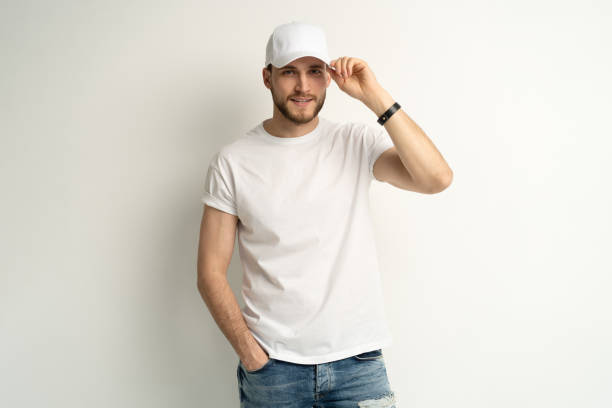istock Handsome man wearing blank white cap and white t-shirt isolated on white background. 1804027976