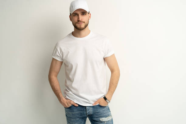 istock Handsome man wearing blank white cap and white t-shirt isolated on white background. 1804027986