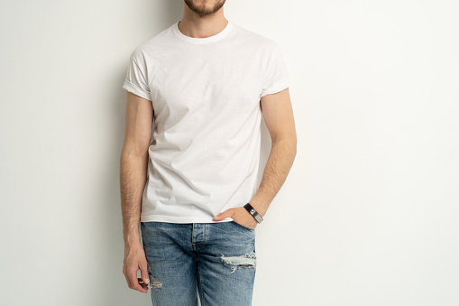 Shirt design and people concept - close up of young man in blank white t-shirt front view isolated.