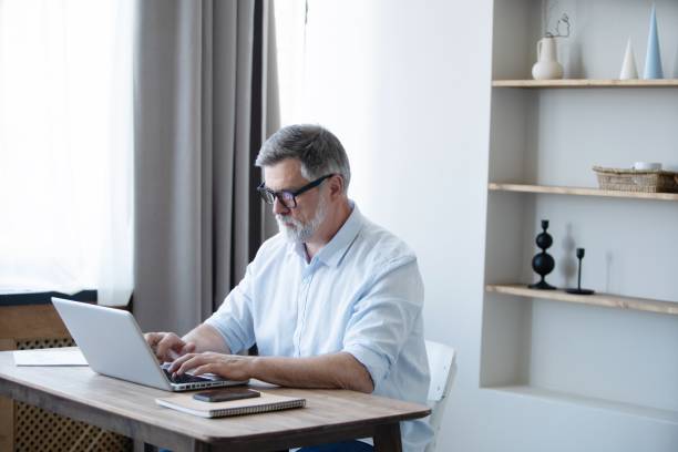 istock Mature businessman working from home using laptop 1804029187