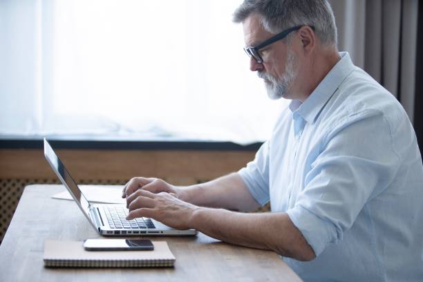 istock Mature businessman working from home using laptop 1804029700