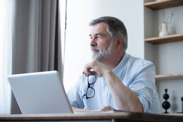 istock Mature businessman working from home using laptop 1804029701