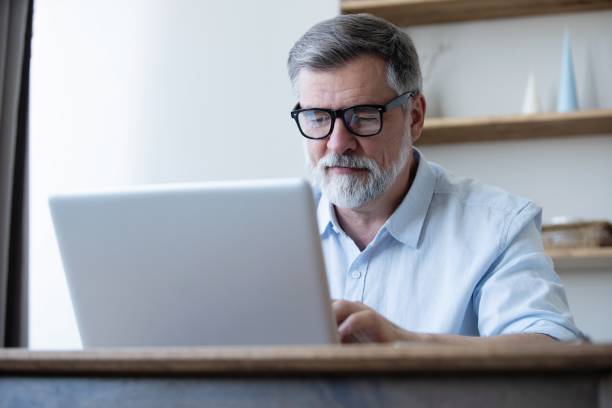 istock Mature businessman working from home using laptop 1804029705