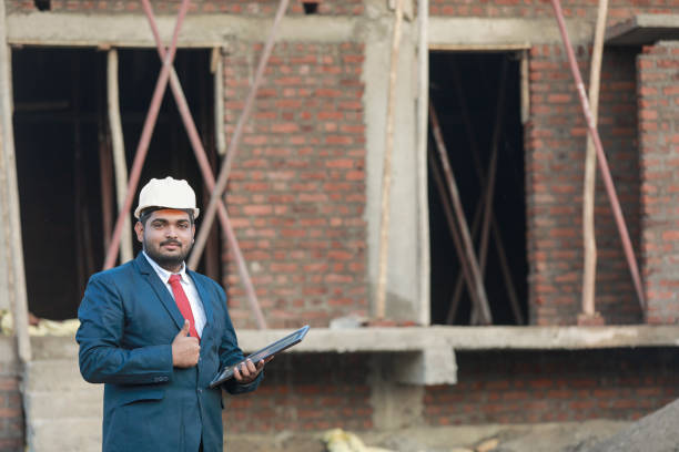 Portrait of civil engineer with safety uniform working at construction site outdoor, Construction worker checking and controlling project on building site, Architecture engineering on new project