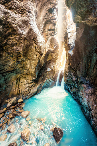 Beautiful waterfall with light shines in Rosenlaui glacier gorge among Swiss Alps at Bernese Alps, Switzerland