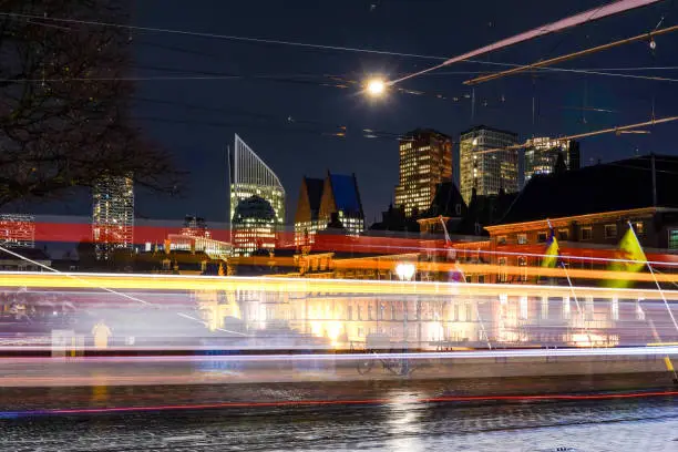 The Hague, Holland The lights of a tram pass by the Parliament building on Plaats, the Town square,  and the downtown.