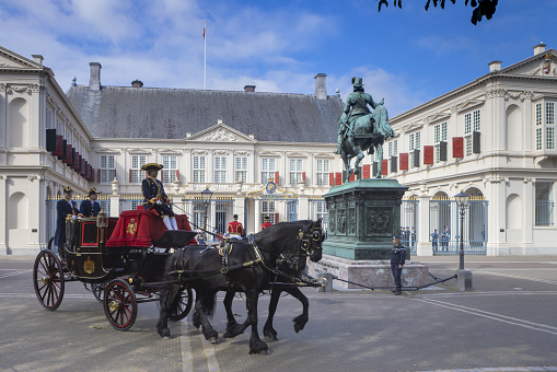 Vienna, Austria - 10 September, 2021: Hofburg Palace and horse carriage on sunny Wien street, popular tourists attraction in Vienna.