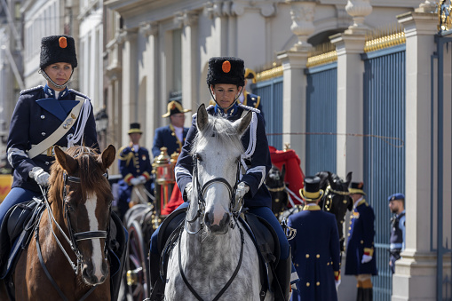 The Hague, The Netherlands - May 24, 2023; royal horsemen at a ceremony in front of Noordeinde Palace on Wednesday mornings when new ambassadors visit King Willem-Alexander and offer him their letter of credence. The audience includes a ceremony that can be followed from Noordeinde street. The ambassadors arrive by state coach, escorted by horsemen from the Royal Netherlands Mounted Police.