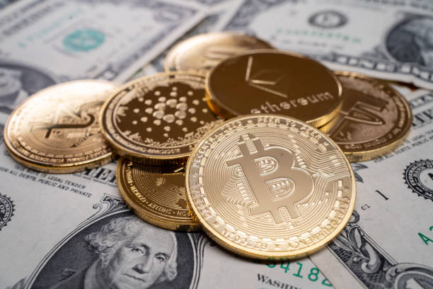 A pile cryptocurrency Veliko Tarnovo, Bulgaria - 11 May 2022: Different cryptocurrency  coins on US dollar notes, showing Benjamin Franklin ether stock pictures, royalty-free photos & images