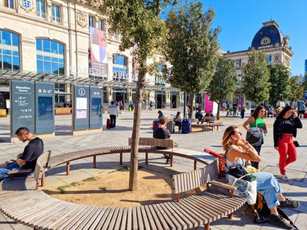 Toulouse-Matabiau is the main railway station in Toulouse, southern France. The current passenger building was built between 1903 and 1905. The image shows the station building with some peple captured during autumn season.