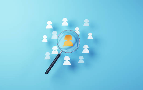 istock Yellow human icon selected in metallic magnifying glass on soft blue background 1804103142