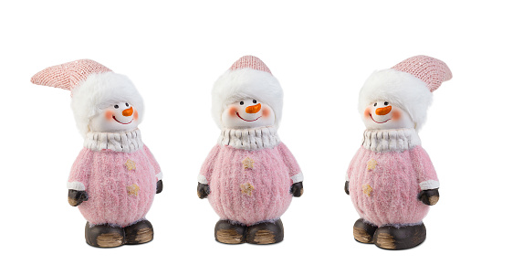 Snowmen in pink clothes wearing hats isolated on white background.
