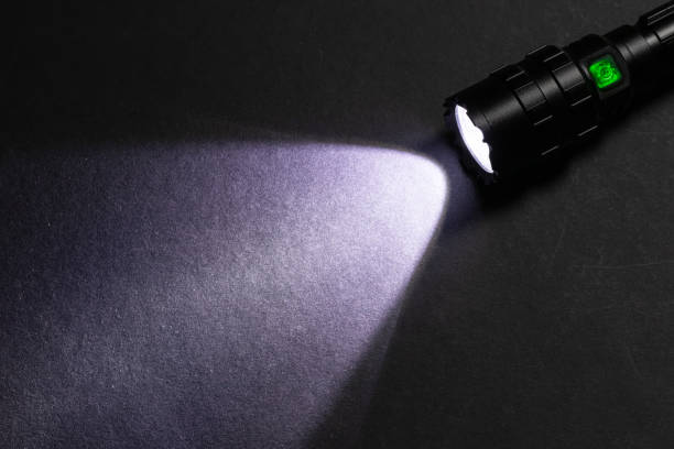 istock Flashlight and beam of light on a dark background 1804121718