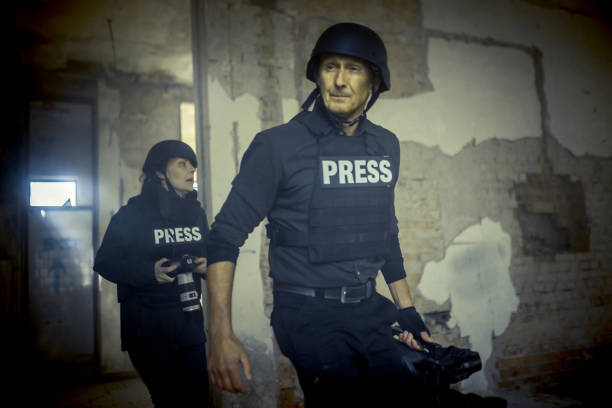 istock journalists in a war zone film soldiers and give an interview 1804126708