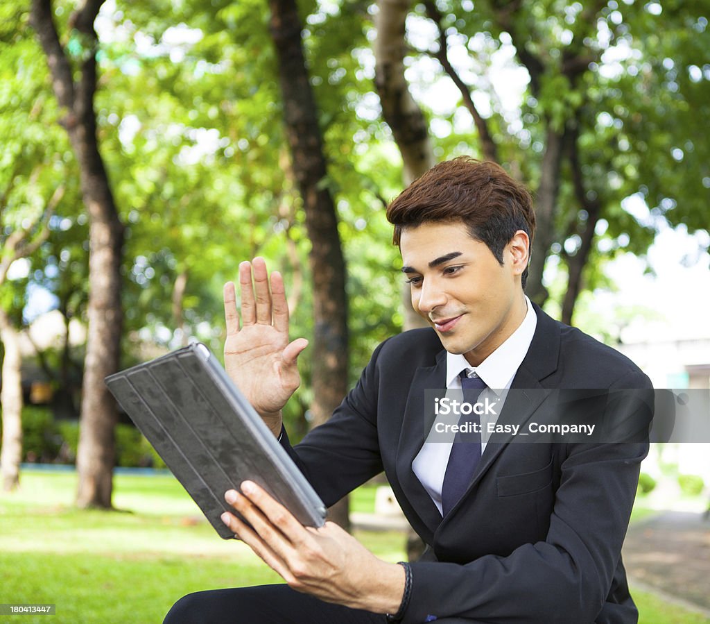 Uomo d'affari che lavorano all'aperto con digital tablet PC al Parco. - Foto stock royalty-free di Adulto