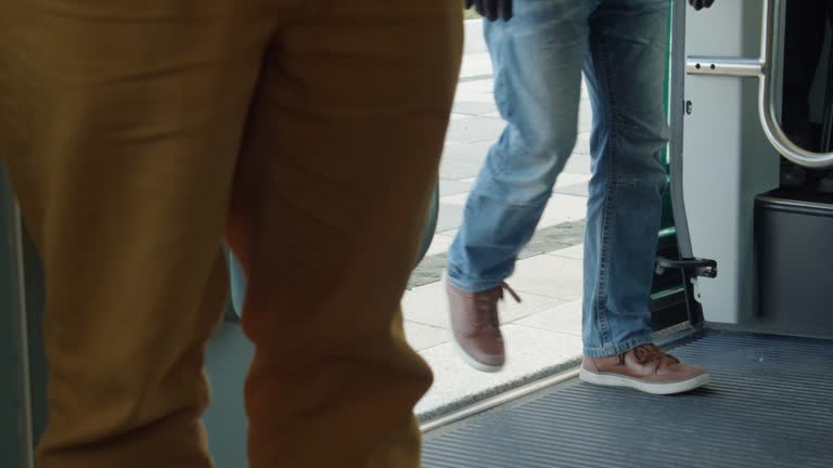 From inside train, Passengers legs and feet boarding commuter train