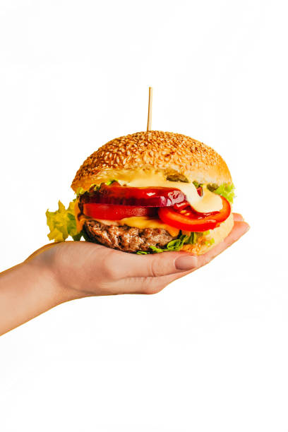 istock close-up of a hamburger in a woman's hand on a white background 1804144917